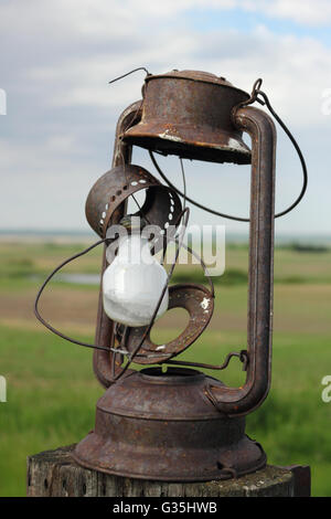 Antique lantern on a fence post on a farm in Alberta, Canada. Stock Photo