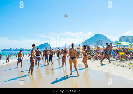 RIO DE JANEIRO - FEBRUARY 27, 2016: Young Brazilian men and women play a game of altinho beach football on Copacabana Beach. Stock Photo