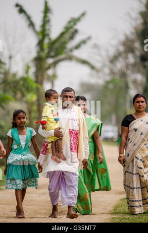 A family walks together in Pan Bari Village in the Kaziranga National Park in India on the 13th April 2016.  Credit: Euan Cherry Stock Photo