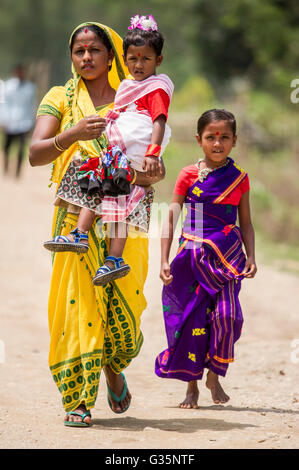 A family walks together in Pan Bari Village in the Kaziranga National Park in India on the 13th April 2016.  Credit: Euan Cherry Stock Photo