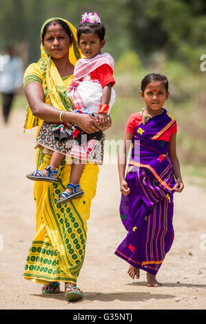 A family walks together in Pan Bari Village in the Kaziranga National Park in India on the 13th April 2016.  Credit: Euan Cherry Stock Photo