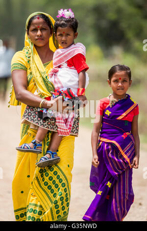 A family walks together in Pan Bari Village in the Kaziranga National Park in India on the 13th April 2016.  Credit: Euan Cherry Stock Photo