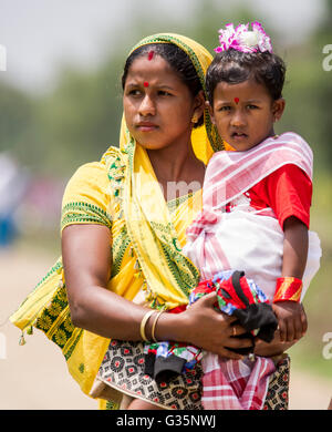 A family walks together in Pan Bari Village in the Kaziranga National Park in India on the 13th April 2016.  Credit: Euan Cherry Stock Photo