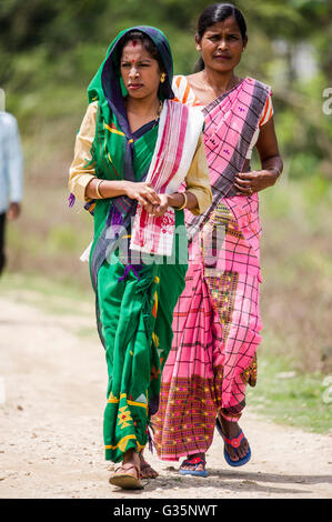 A family walks together in Pan Bari Village in the Kaziranga National Park in India on the 13th April 2016.  Credit: Euan Cherry Stock Photo