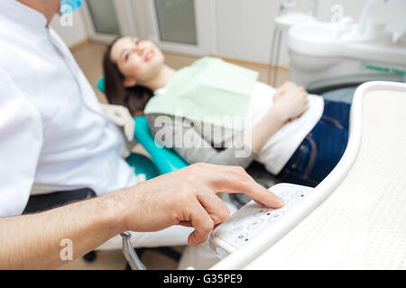 Male dentist using computer in his work with female patient Stock Photo