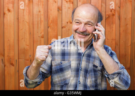 Elderly man talking on the phone. Maintaining family ties at a distance. Order by phone Stock Photo
