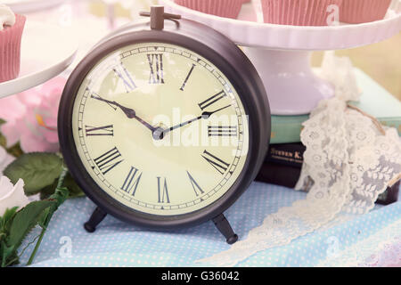 A clock, Alice in wonderland Mad Hatters tea party, toning Stock Photo