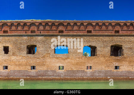 One of the brick walls of Fort Jefferson, with its moat, on Garden Key in Dry Tortugas National Park, Florida, USA Stock Photo