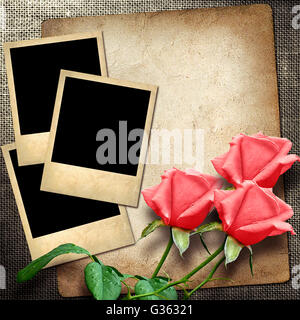 old photo on a linen background  with red roses in vintage style Stock Photo