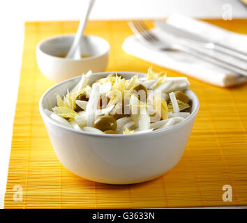 A salad in a bowl with onion, olives and celery Stock Photo