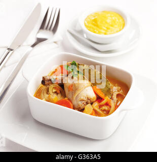 A tasty rabbit dish with a sauce of onion, carrot, garlic and bay leaves. Stock Photo