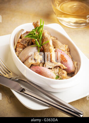 Rabbit prepared with onions and mushrooms Stock Photo