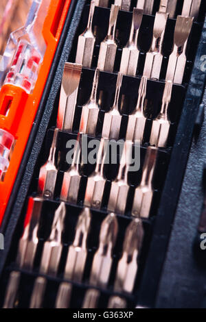 set of nozzles for screwdriver  in red box on wooden background Stock Photo