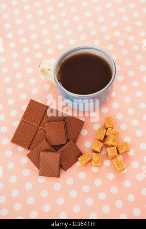 blue cup of tea and lump sugar on pink  background Stock Photo