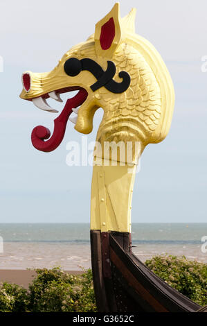 Carved wooden figurehead on the prow of the replica Viking ship Hugin at Pegwell Bay, Kent. Stock Photo