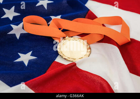Close-up of gold medal on american flag Stock Photo