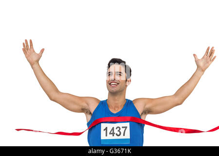 Cheerful winner athlete crossing finish line Stock Photo