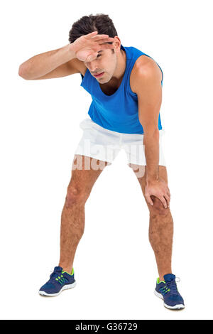 Tired athlete wiping his sweat with hand Stock Photo