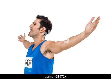 Excited male athlete with arms outstretched Stock Photo