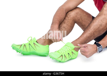 Male athlete tying his running shoes Stock Photo