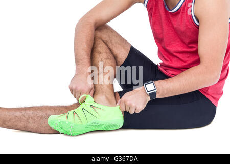 Male athlete wearing his sport shoes and getting ready for sport Stock Photo