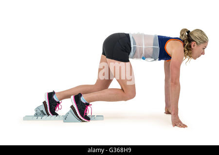 Female athlete in position ready to run Stock Photo