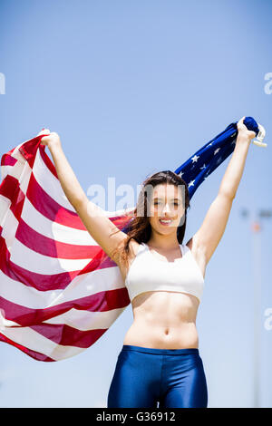 Female athlete holding an american flag Stock Photo