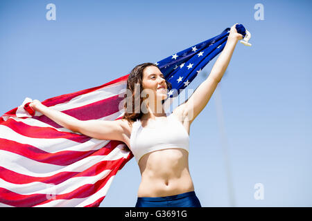 Female athlete holding an american flag Stock Photo