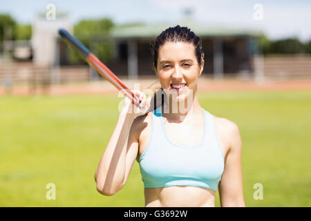 Portrait of female athlete holding a javelin Stock Photo