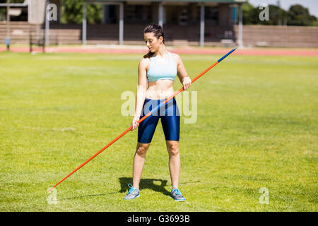 Female athlete holding a javelin in stadium Stock Photo