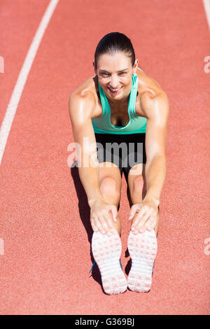 Portrait of female athlete doing stretching exercise Stock Photo