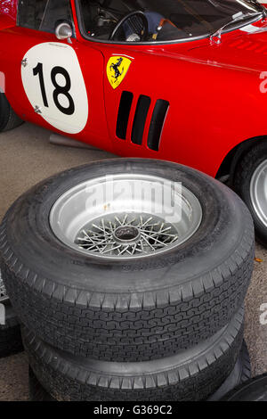 Tyres stacked beside the 1963 Ferrari 250 GTO/64 in the paddock at the 2015 Goodwood Revival, Sussex, UK. Stock Photo