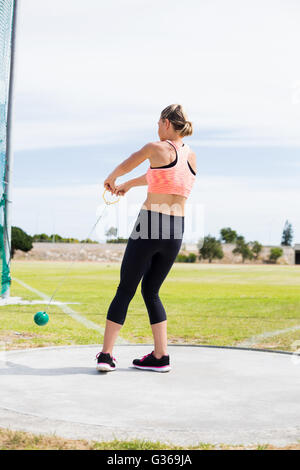 Female athlete performing a hammer throw Stock Photo