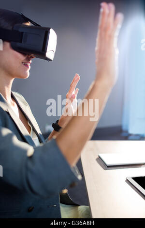 Businesswoman using an oculus Stock Photo
