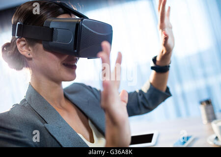 Businesswoman using an oculus Stock Photo