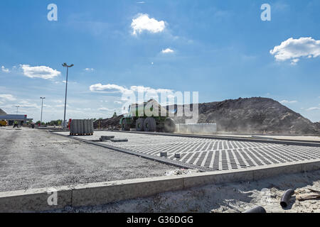 View at new parking place. Dumper truck is going over construction site in background. Stock Photo