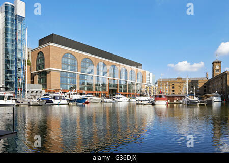 View across marina towards refurbished office building. Commodity Quay, London, United Kingdom. Architect: BuckleyGrayYeoman, 2014. Stock Photo