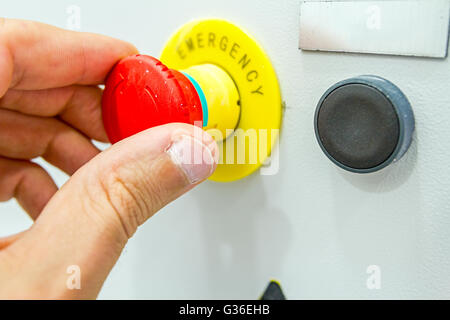 Hand is operating a heavy duty switch on electrical cabinet providing electrical energy to residential place. Stock Photo