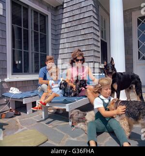 U.S President John F. Kennedy relaxes with First Lady Jacqueline Kennedy, daughter Caroline and son John on Squaw Island August 14, 1963 in Hyannis Port, Massachusetts. Stock Photo