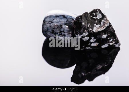 close up shot of a fragment of obsidian mineral on a dark surface Stock Photo