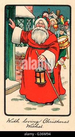 Father Christmas delivering Xmas presents Stock Photo