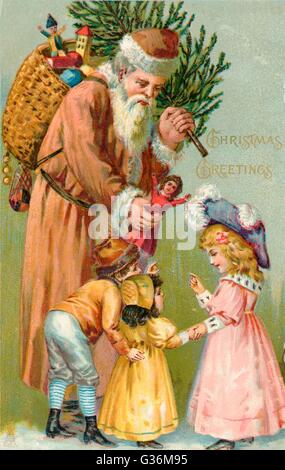 Father Christmas delivering Xmas presents Stock Photo