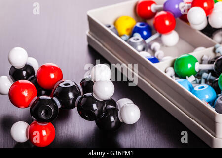 a plastic molecule structure modeling kit on a wooden surface Stock Photo