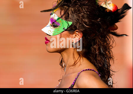 A young Mexican woman in a mask during a local festival holiday in Barra de Navidad Mexico. Stock Photo