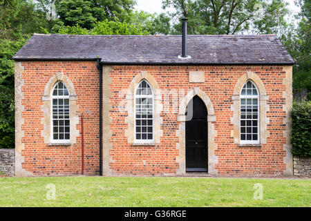 Converted chapel house with arched windows and door in Black Bourton. Oxfordshire, England Stock Photo