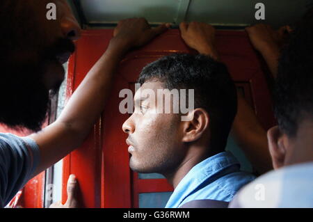 A man standing on a jam-packed train from Colombo to Kandy, Sri Lanka. Stock Photo
