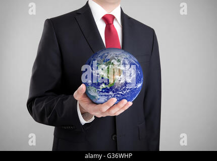 Businessman holding globe. Clipping path included. Earth image provided by Nasa. Stock Photo