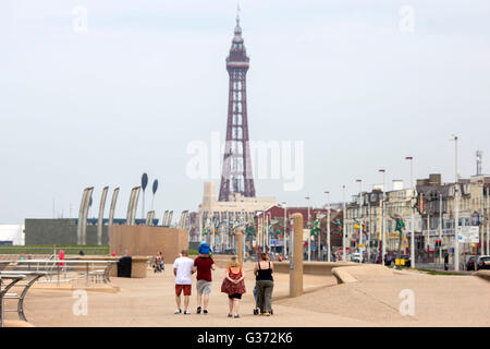 Blackpool in summer. A family walk along the promenade with Blackpool Tower in the background of the picture. Stock Photo