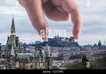 A different perspective of Edinburgh Castle - a man's hand looking like it is picking up or laying down Edinburgh Castle Stock Photo
