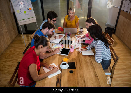Casual business team taking notes Stock Photo